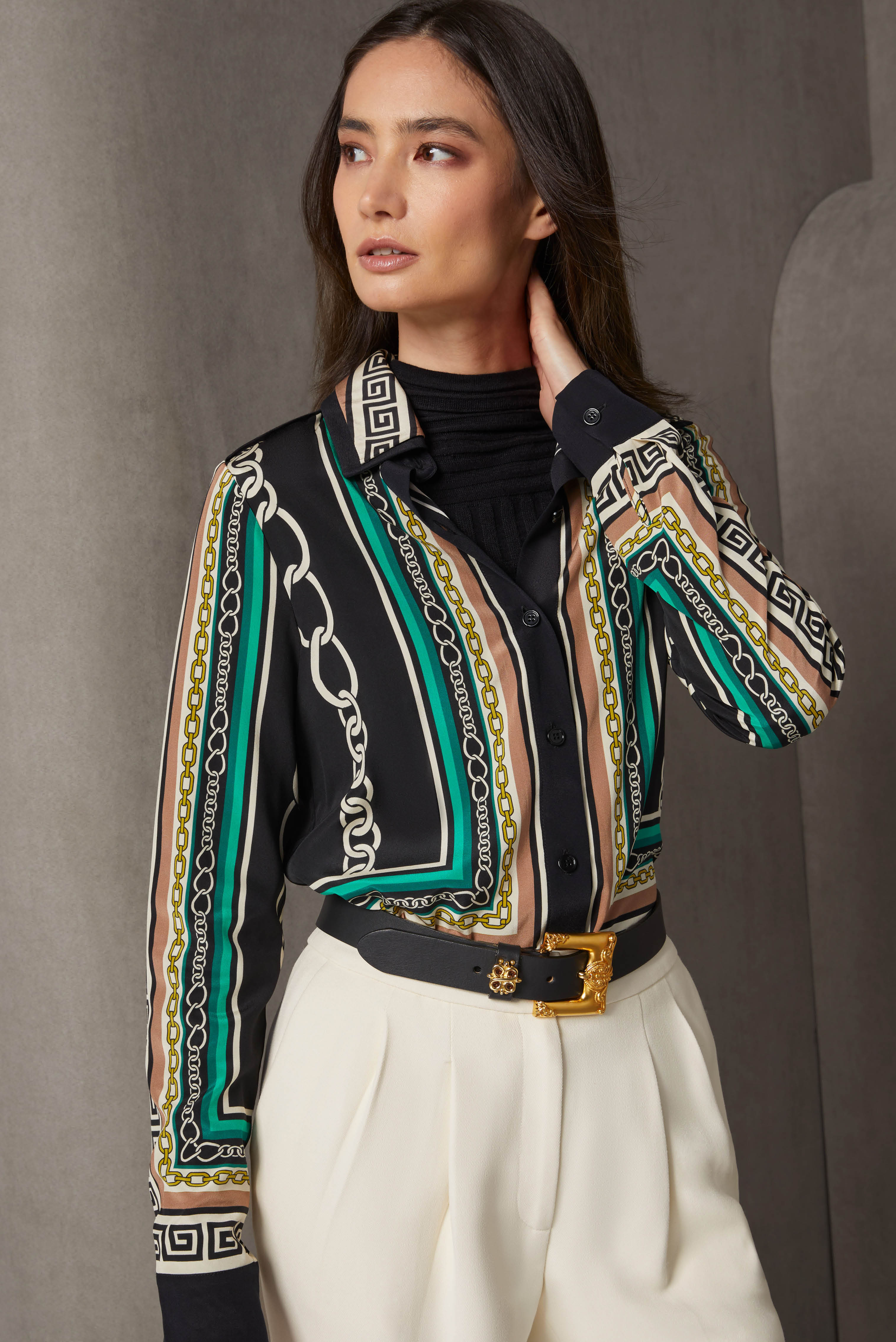 Layer on splendid textures, patterns, and fabrics. The six-color blouse is fluid silk crêpe de chine, printed with different chain, meander, and frame patterns. The solid black under-collar, placket, and cuffs echo the silk-rich mock turtleneck layer.