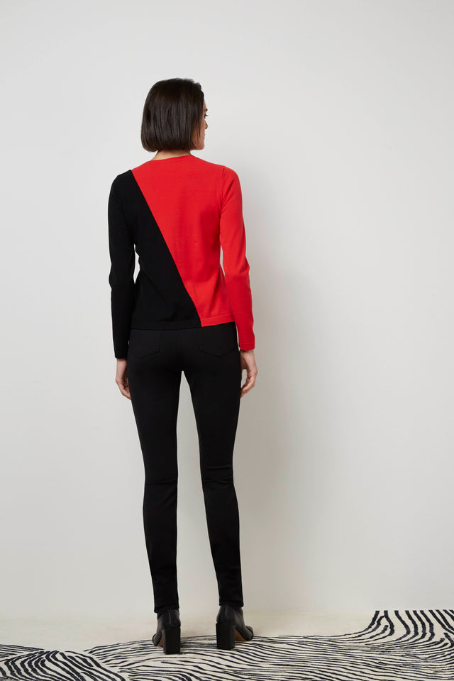 Back of a woman wearing a red 'Iconoclast' sweater