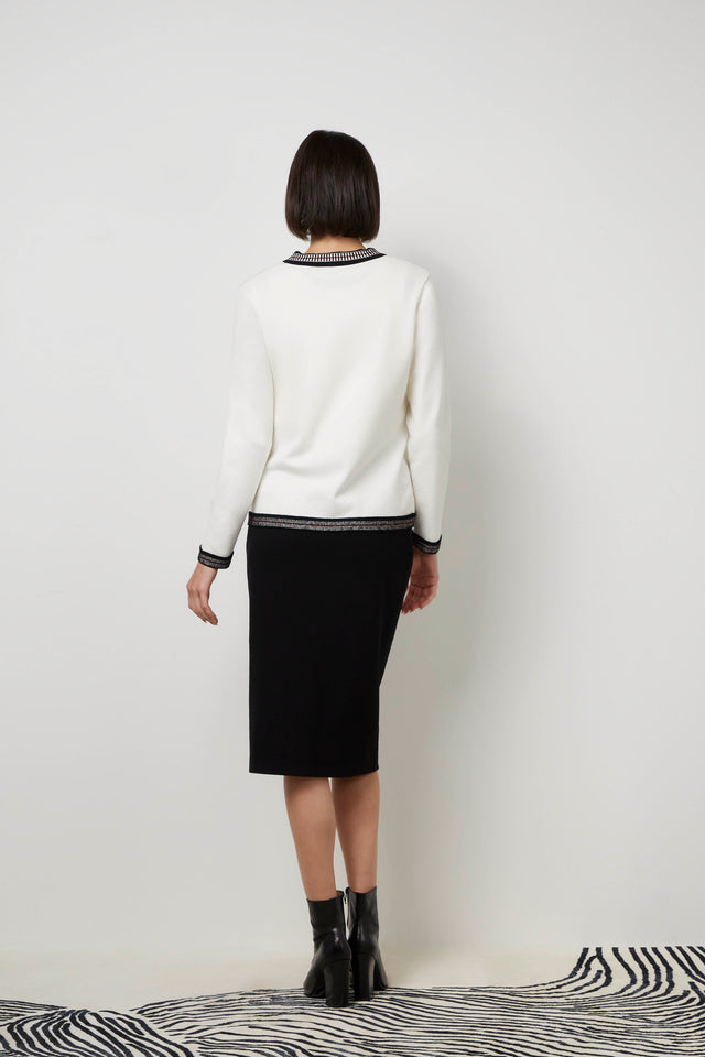 Back of a woman wearing a white 'Sleighing' jacket