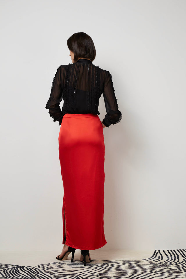 Back of a woman wearing a red 'Torch song' skirt